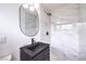 Updated bathroom featuring modern vanity, elegant mirror, and tiled shower with marble accents at 516 Donner St, Las Vegas, NV 89107