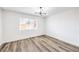 Bedroom features wood flooring, natural light from the window, and contemporary light fixture at 516 Donner St, Las Vegas, NV 89107