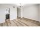 Bright bedroom featuring modern light fixture, wood flooring, a closet, and an ensuite bathroom at 516 Donner St, Las Vegas, NV 89107