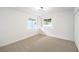 Spacious bedroom with neutral carpet, natural light from two windows, and a modern light fixture at 516 Donner St, Las Vegas, NV 89107