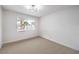 Bedroom featuring neutral carpet, bright windows, white walls, and modern lighting at 516 Donner St, Las Vegas, NV 89107