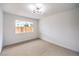 Bedroom showcasing neutral carpet, natural light, and a modern light fixture at 516 Donner St, Las Vegas, NV 89107