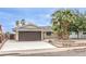 Charming single-story house with a large driveway, desert landscaping, and a two-car garage at 516 Donner St, Las Vegas, NV 89107