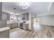 Open-concept kitchen with gray cabinets, stainless steel appliances, and an adjoining living area with wood flooring at 516 Donner St, Las Vegas, NV 89107