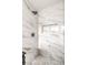 Modern tiled shower featuring marble accents, a built-in niche, and sleek fixtures at 516 Donner St, Las Vegas, NV 89107