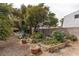 Backyard featuring garden beds and mature trees, perfect for gardening and outdoor enjoyment at 5260 Styers St, North Las Vegas, NV 89031