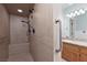 Accessible shower in bathroom featuring grab bars, built-in bench, and tile surround at 5260 Styers St, North Las Vegas, NV 89031