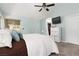 Spacious bedroom with pale blue walls, carpet flooring, and a television mounted on the wall at 5260 Styers St, North Las Vegas, NV 89031