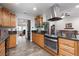 Updated kitchen featuring stainless steel appliances, tile floors, and wooden cabinets at 5260 Styers St, North Las Vegas, NV 89031