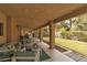 Covered patio with cushioned seating and views of the landscaped backyard at 5260 Styers St, North Las Vegas, NV 89031
