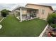 Spacious backyard features artificial grass, a covered patio, and outdoor cooking area at 5318 Rio Eldorado Ct, North Las Vegas, NV 89031
