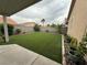 Manicured backyard featuring artificial turf, rock features, and garden planters at 5318 Rio Eldorado Ct, North Las Vegas, NV 89031
