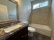 Bright bathroom featuring a granite countertop vanity and tiled shower-over-tub at 5318 Rio Eldorado Ct, North Las Vegas, NV 89031
