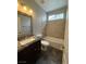 This bathroom features a shower over bath and a single sink with a dark granite countertop at 5318 Rio Eldorado Ct, North Las Vegas, NV 89031