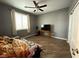 Bedroom with wood-look flooring, ceiling fan, and a window bringing in natural light at 5318 Rio Eldorado Ct, North Las Vegas, NV 89031