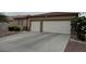 Home exterior featuring a two-car garage and low-maintenance landscaping at 5318 Rio Eldorado Ct, North Las Vegas, NV 89031