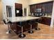 Gourmet kitchen with granite counters, an island with seating, and sleek cabinetry at 5318 Rio Eldorado Ct, North Las Vegas, NV 89031