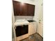 Laundry room featuring a white washer and dryer set and dark wood cabinetry at 5318 Rio Eldorado Ct, North Las Vegas, NV 89031