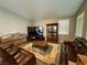Living room featuring wood-look floors, a modern TV, and a comfortable brown leather sofa at 5318 Rio Eldorado Ct, North Las Vegas, NV 89031