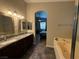 The main bathroom features a soaking tub and double sinks with granite countertops at 5318 Rio Eldorado Ct, North Las Vegas, NV 89031