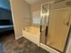 This main bathroom features a soaking tub with a glass enclosed shower and an entrance to the main bedroom at 5318 Rio Eldorado Ct, North Las Vegas, NV 89031