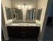 This main bathroom features double sinks with granite countertops and views to the shower and bedroom at 5318 Rio Eldorado Ct, North Las Vegas, NV 89031