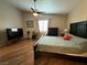 This main bedroom features a ceiling fan, dark wood flooring, and a large bed at 5318 Rio Eldorado Ct, North Las Vegas, NV 89031
