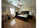 This main bedroom features a ceiling fan, dark wood flooring, and an attached office space at 5318 Rio Eldorado Ct, North Las Vegas, NV 89031