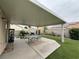 Covered patio with table, cooking area, landscaped yard and artificial grass at 5318 Rio Eldorado Ct, North Las Vegas, NV 89031