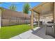 Backyard with artificial turf and a covered patio with outdoor furniture at 5409 Cruz Crest Ct, North Las Vegas, NV 89081