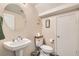 Cozy powder room featuring a pedestal sink, toilet, and framed decorative art at 5409 Cruz Crest Ct, North Las Vegas, NV 89081