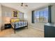 Cozy bedroom with a ceiling fan, large window, and decorative wall art at 5409 Cruz Crest Ct, North Las Vegas, NV 89081