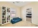 Bright bonus bedroom with a blue sofa, built-in bookshelf, and view of the main bedroom at 5409 Cruz Crest Ct, North Las Vegas, NV 89081