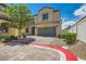 Charming two-story home showcasing a well-maintained front yard with brick driveway and a two-car garage at 5409 Cruz Crest Ct, North Las Vegas, NV 89081