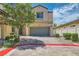 Charming two-story home showcasing a well-maintained front yard with brick driveway and a two-car garage at 5409 Cruz Crest Ct, North Las Vegas, NV 89081