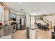 Modern kitchen and dining area with granite countertops, stainless appliances, open staircase, and tile floors at 5409 Cruz Crest Ct, North Las Vegas, NV 89081