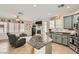 Modern kitchen features granite countertops, stainless steel appliances, and an open view to the living room at 5409 Cruz Crest Ct, North Las Vegas, NV 89081
