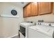 Functional laundry room with modern washer and dryer units and overhead cabinetry at 5409 Cruz Crest Ct, North Las Vegas, NV 89081