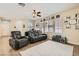 Open living room with tile floors, neutral walls, ceiling fan, comfortable seating and bright natural light at 5409 Cruz Crest Ct, North Las Vegas, NV 89081