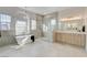 Bright primary bathroom featuring soaking tub, shower, and vanity at 5737 Heather Breeze Ct, Las Vegas, NV 89141