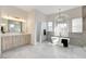 Bright bathroom with double vanity, soaking tub, and modern finishes at 5737 Heather Breeze Ct, Las Vegas, NV 89141