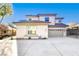 Two-story house with a beige stucco exterior, tile roof, and a three-car garage at 5737 Heather Breeze Ct, Las Vegas, NV 89141