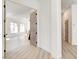 Hallway with a view of the living room, hardwood flooring, and neutral walls at 5737 Heather Breeze Ct, Las Vegas, NV 89141