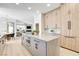 Modern kitchen with an island, built-in oven, and light wood cabinets at 5737 Heather Breeze Ct, Las Vegas, NV 89141