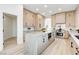 Well-lit kitchen with an island, stainless steel appliances, and light wood cabinets at 5737 Heather Breeze Ct, Las Vegas, NV 89141
