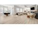 Open floor plan with a view of living room and dining area with light hardwood flooring and neutral walls at 5737 Heather Breeze Ct, Las Vegas, NV 89141