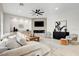 Bright living room with a modern fireplace, ceiling fan, and light hardwood flooring at 5737 Heather Breeze Ct, Las Vegas, NV 89141