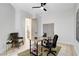 Bright office with a wooden desk, woven rug, natural lighting, and neutral walls at 5737 Heather Breeze Ct, Las Vegas, NV 89141