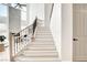 Elegant staircase with wood and wrought iron railing, complemented by light hardwood floors at 5737 Heather Breeze Ct, Las Vegas, NV 89141