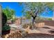Backyard offers a greenhouse, garden plots, trees and charming picket fence, creating a serene outdoor oasis at 5949 Casa Coronado Ave, Las Vegas, NV 89131